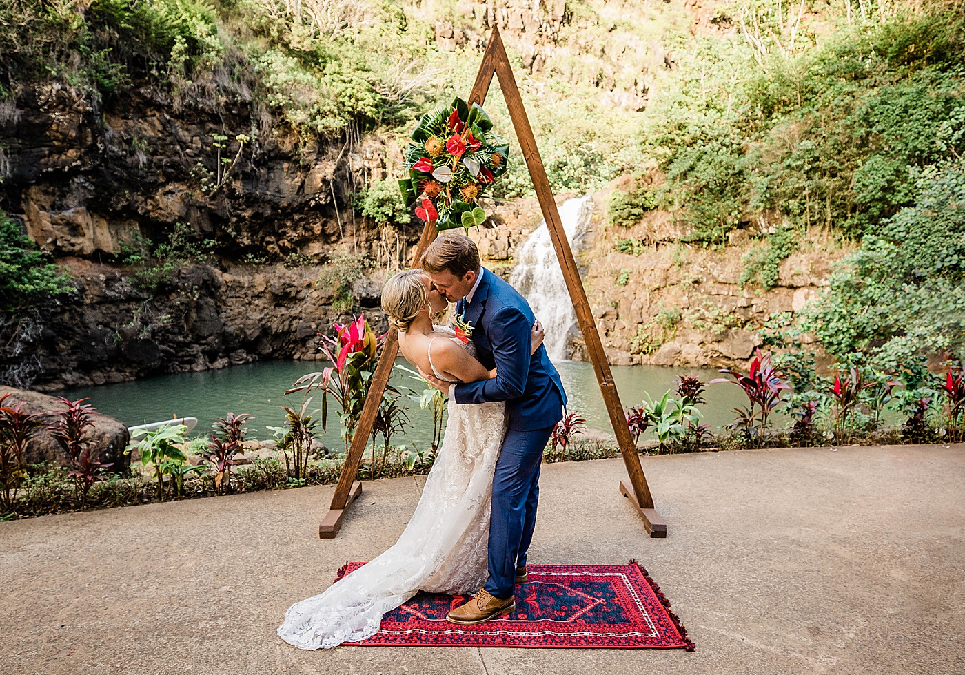 Bride and groom first kiss during Waimea Valley wedding ceremony.