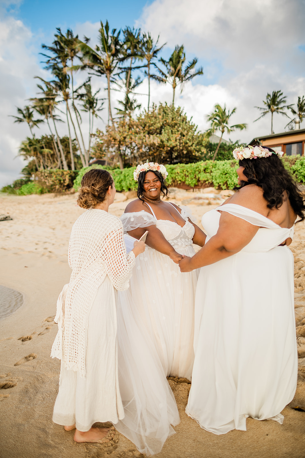 Two women getting married on the beach during their LGBTQ+ friendly elopement in Hawaii