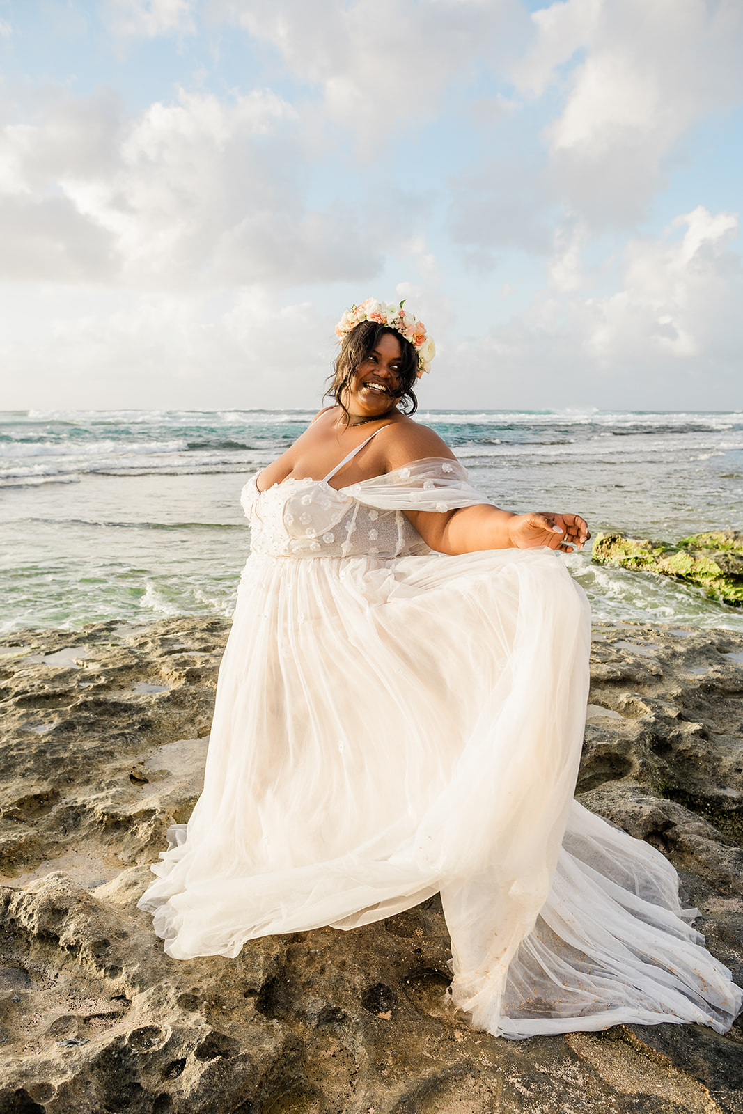 Woman spinning joyfully in her wedding dress during her elopement on Oahu
